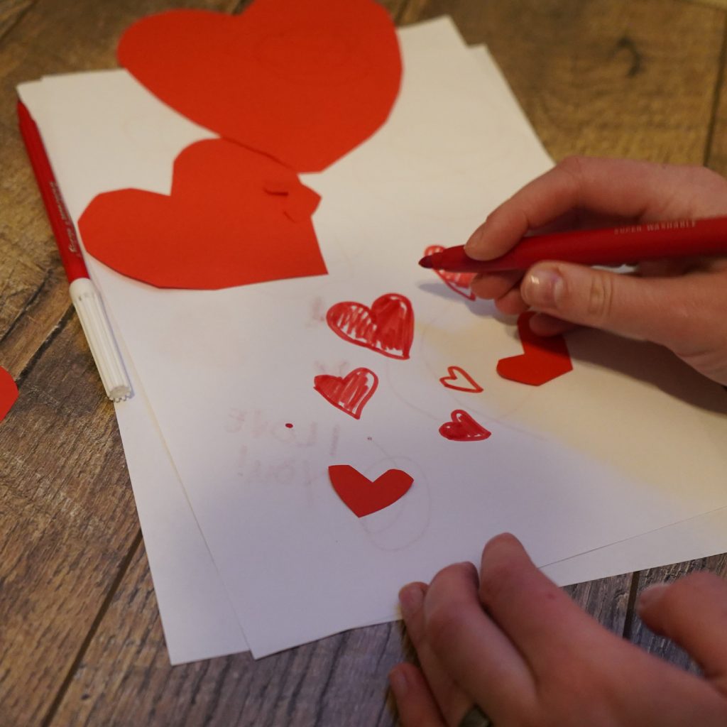 Valentines card with red love hearts drawn in marker